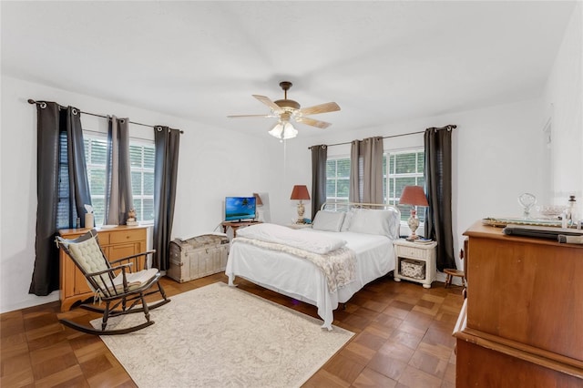 bedroom featuring dark parquet flooring and ceiling fan