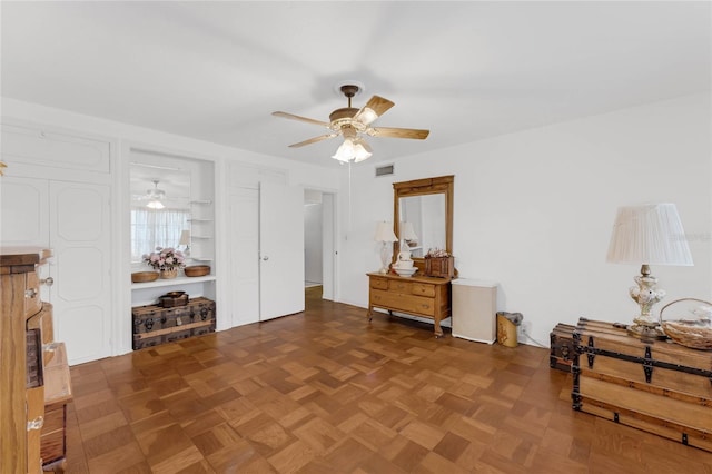 interior space with parquet flooring and ceiling fan