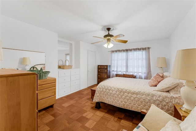 bedroom with parquet floors and ceiling fan