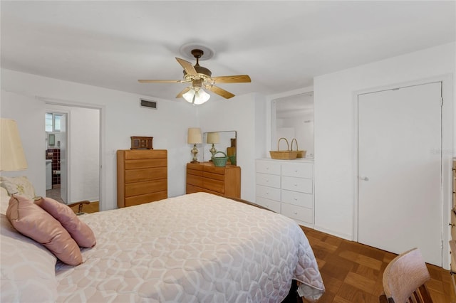 bedroom with dark parquet flooring and ceiling fan