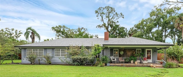 single story home featuring covered porch and a front lawn