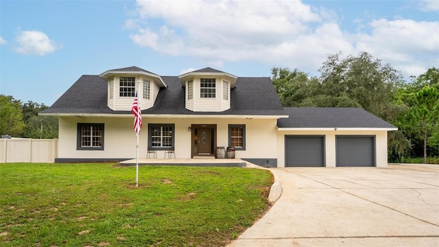 view of front of home with a front lawn and a garage