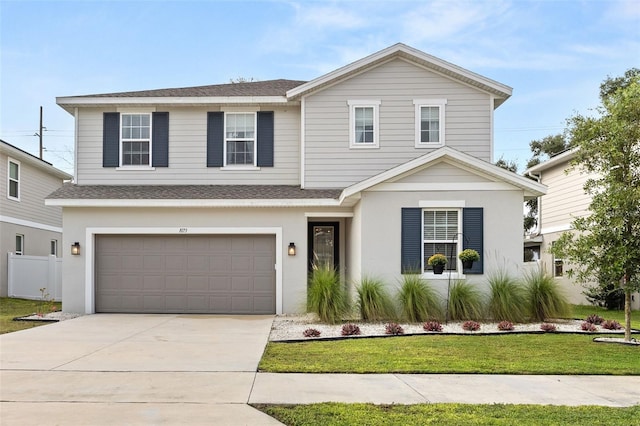 view of front of home featuring a front lawn and a garage