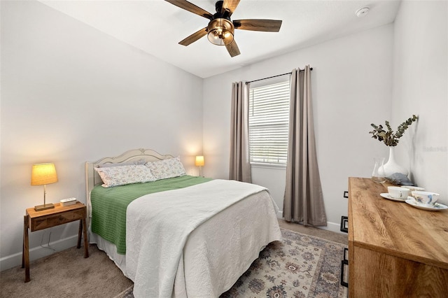 carpeted bedroom with ceiling fan and vaulted ceiling