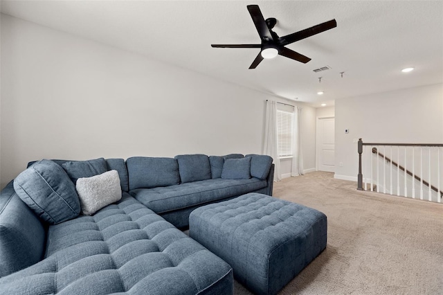 living room with ceiling fan and light colored carpet