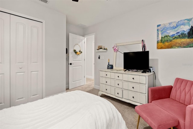 carpeted bedroom with a closet