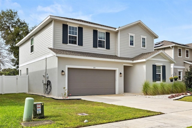 view of front facade with a garage and a front lawn