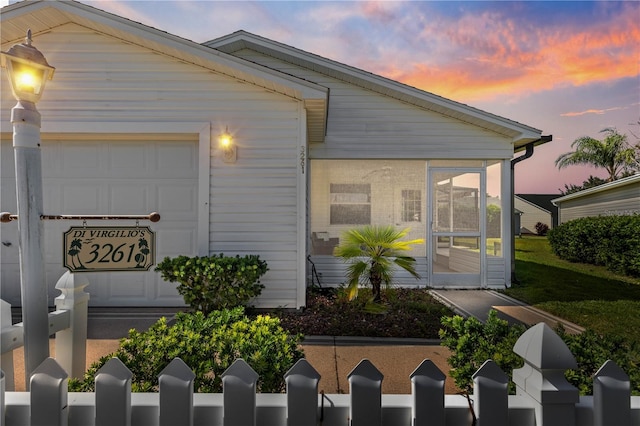 view of front of home featuring a sunroom