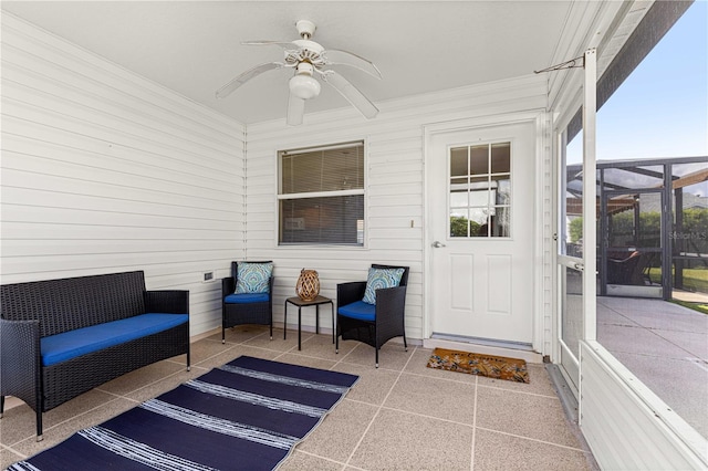 sunroom featuring ceiling fan