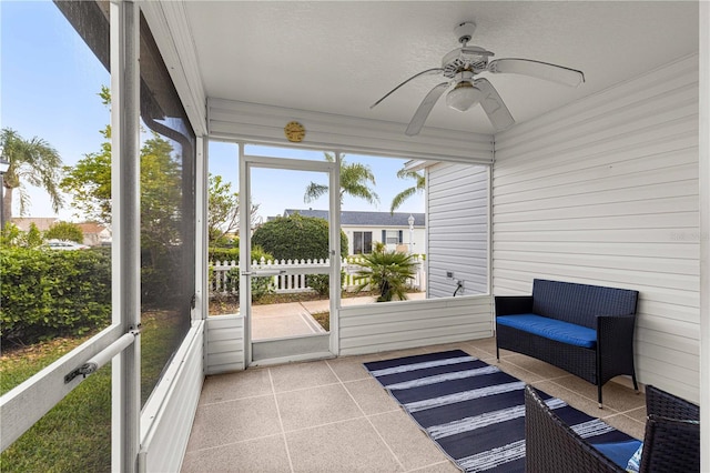 sunroom featuring ceiling fan