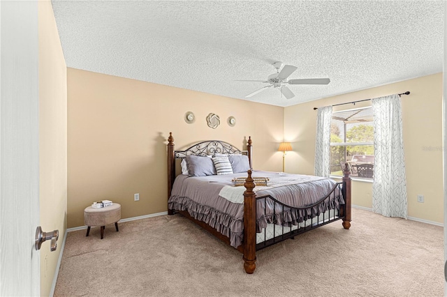 bedroom featuring light carpet, a textured ceiling, and ceiling fan