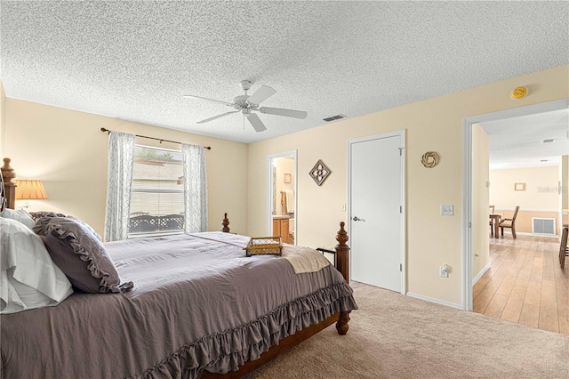 carpeted bedroom with a textured ceiling and ceiling fan