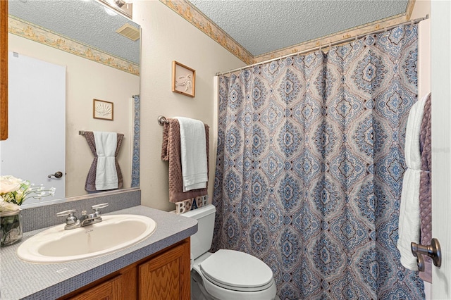 bathroom with toilet, a textured ceiling, walk in shower, and vanity