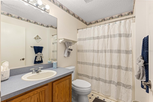 bathroom with vanity, toilet, a textured ceiling, and walk in shower