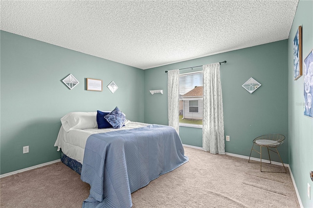 carpeted bedroom featuring a textured ceiling