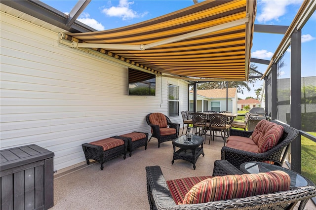 view of patio with glass enclosure and an outdoor hangout area