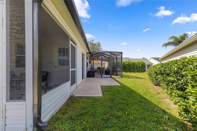 view of yard with a patio area and glass enclosure