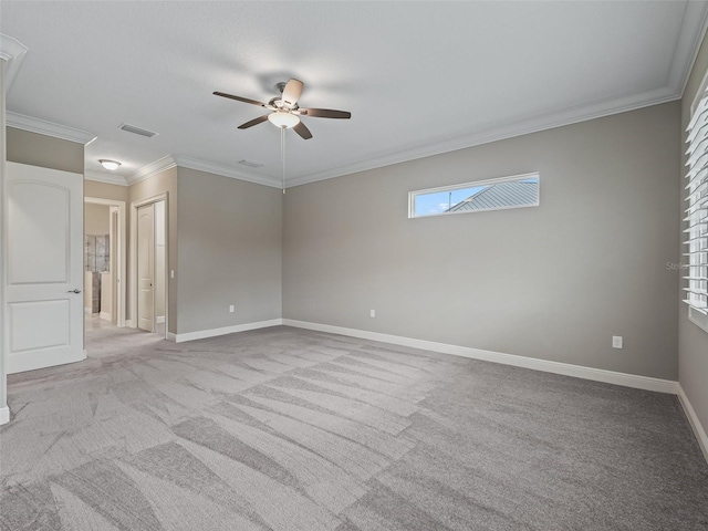 carpeted empty room with ceiling fan and ornamental molding