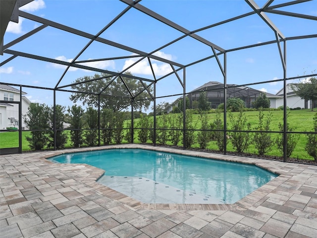 view of swimming pool featuring a patio and a lanai