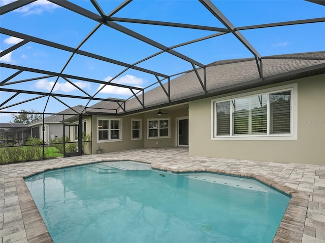 view of pool featuring a patio, ceiling fan, and a lanai