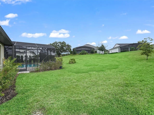 view of yard with glass enclosure