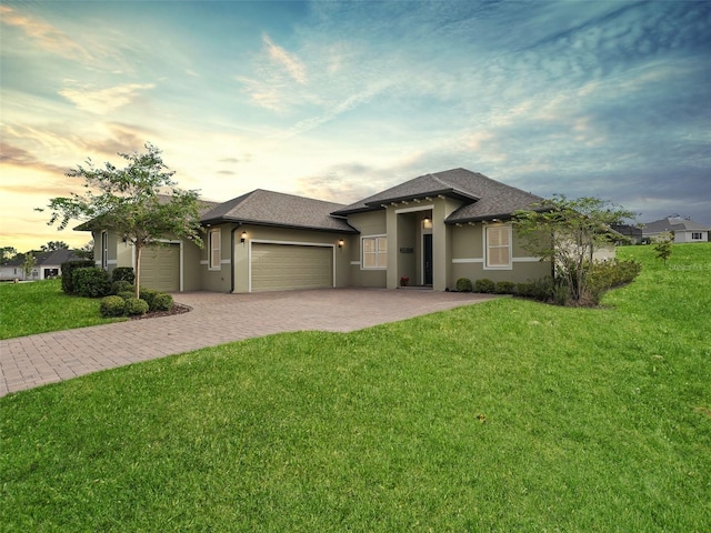 prairie-style house with a garage and a yard