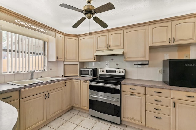 kitchen with ceiling fan, light tile patterned floors, sink, appliances with stainless steel finishes, and light brown cabinetry