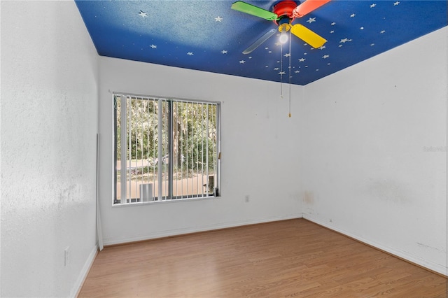 empty room with light hardwood / wood-style floors and ceiling fan