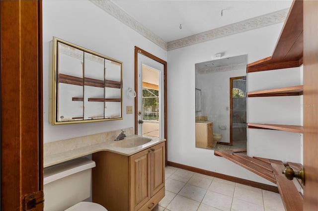 bathroom featuring a tile shower, tile patterned flooring, vanity, and toilet