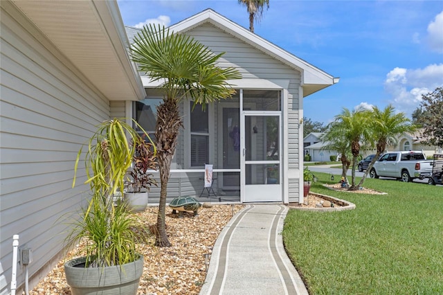 doorway to property with a lawn