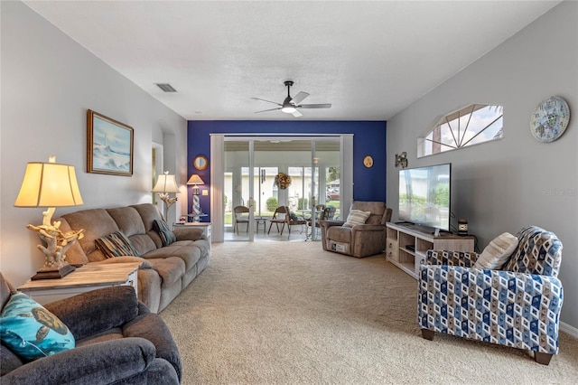 carpeted living room with ceiling fan