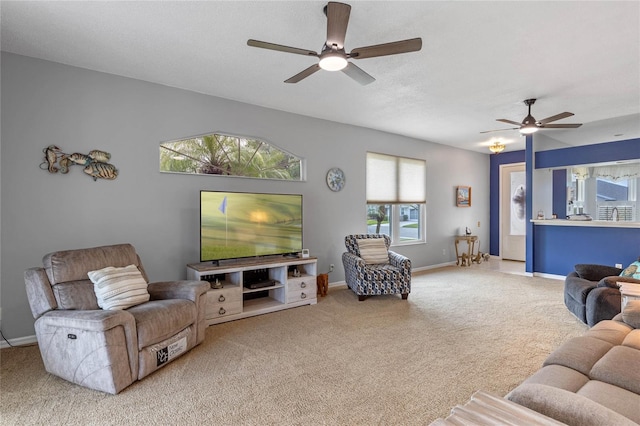 carpeted living room featuring ceiling fan