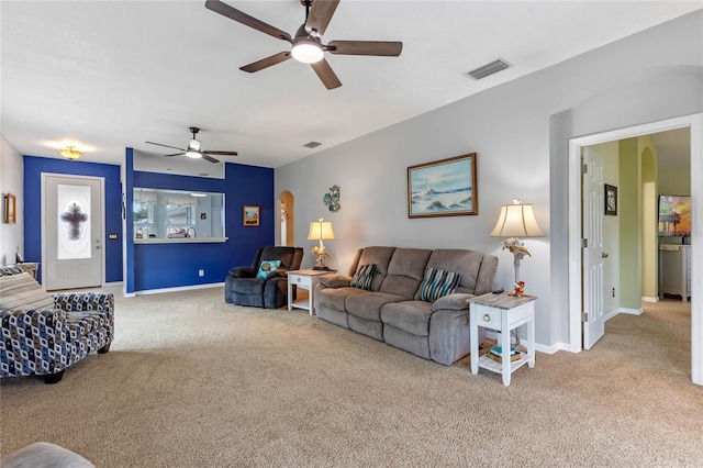 carpeted living room with ceiling fan