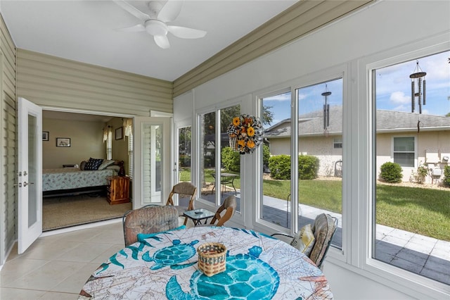 sunroom / solarium featuring ceiling fan