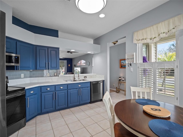 kitchen with blue cabinets, appliances with stainless steel finishes, ceiling fan, and sink