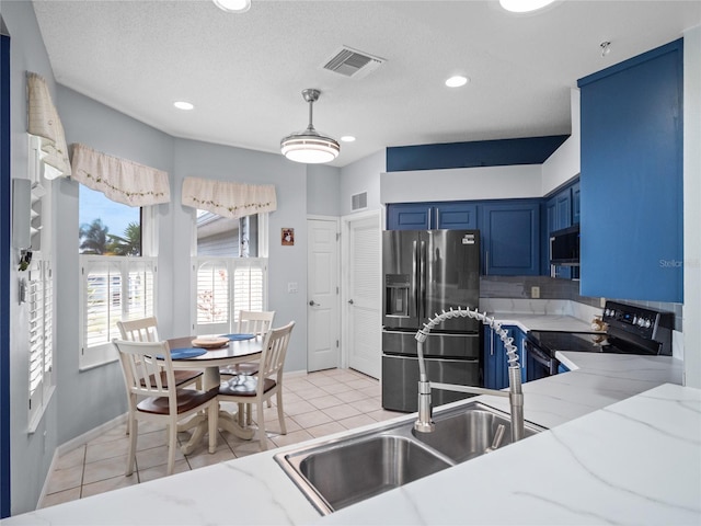 kitchen with light tile patterned floors, stainless steel fridge with ice dispenser, blue cabinetry, and black / electric stove