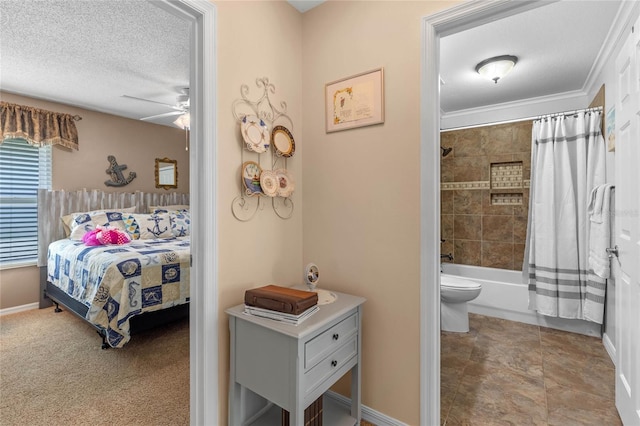 bedroom with ceiling fan, connected bathroom, crown molding, and a textured ceiling