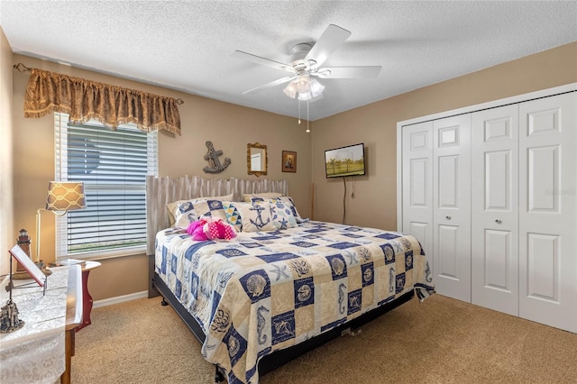 bedroom with a closet, ceiling fan, a textured ceiling, and light colored carpet