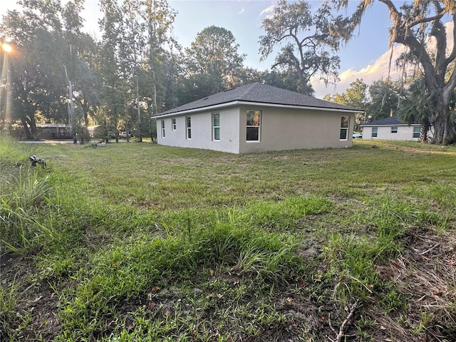 view of side of property featuring a yard