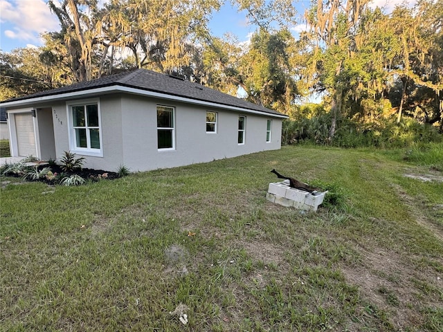 view of side of home with a lawn