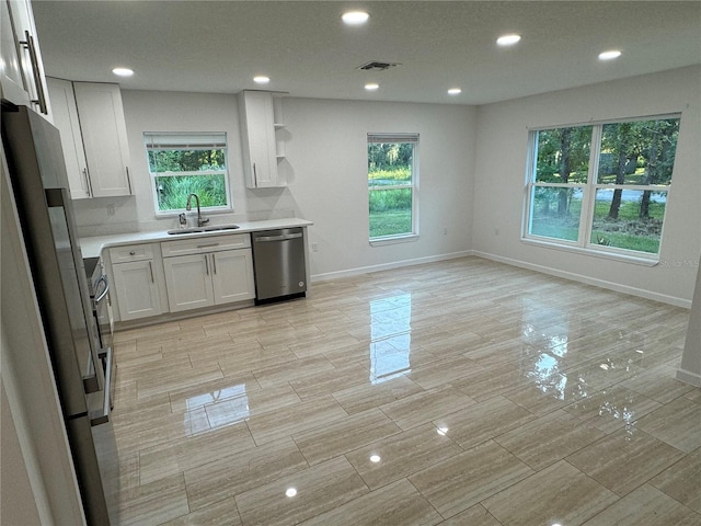 kitchen featuring white cabinetry, sink, and stainless steel dishwasher