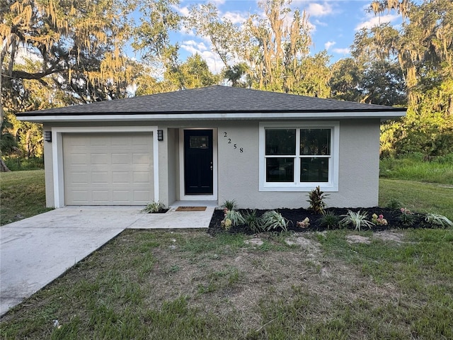 ranch-style house with a garage and a front lawn