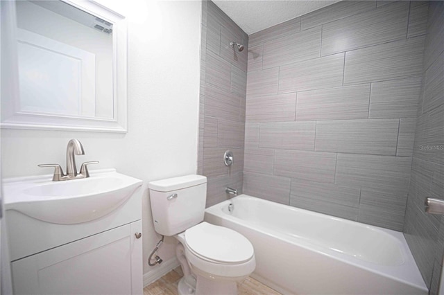 full bath with toilet, tub / shower combination, a textured ceiling, and vanity