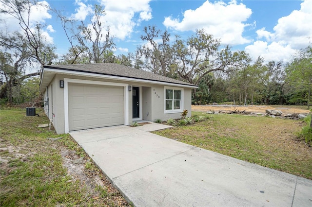 view of front facade featuring driveway, a garage, a front lawn, and stucco siding