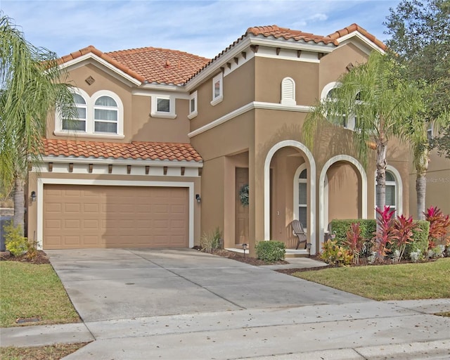 mediterranean / spanish-style house with a garage