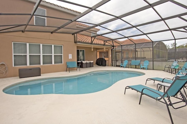 view of pool with a patio and glass enclosure