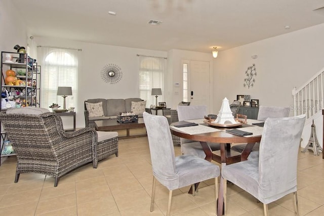 tiled dining room with a healthy amount of sunlight