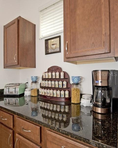 kitchen featuring dark stone countertops