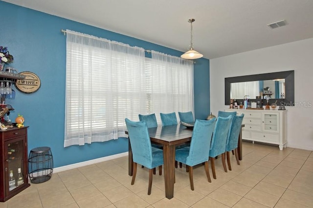 tiled dining space featuring plenty of natural light