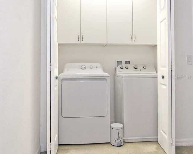 laundry area featuring cabinets and separate washer and dryer